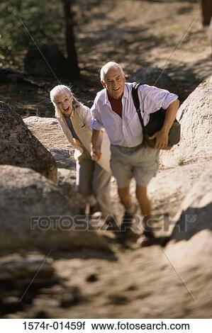 Stock Image - Portrait of a senior couple hiking. Fotosearch