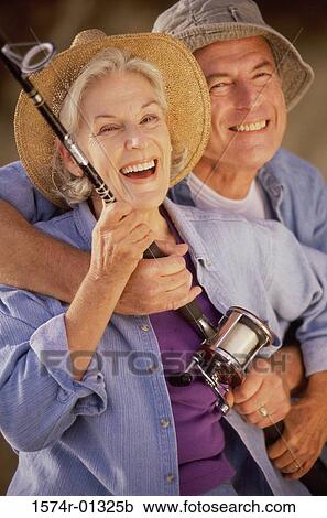 Portrait of a senior couple holding a fishing rod View Large Photo Image Stock Image - Portrait of a senior couple holding a fishing rod. Fotosearch