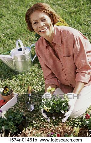 Stock Image - Portrait of a senior woman gardening. Fotosearch