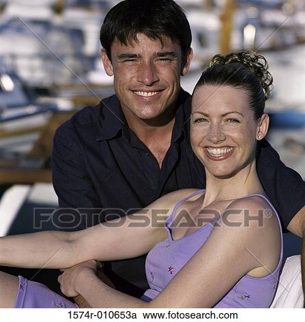 Portrait of a young couple sitting together View Large Photo Image Stock Image - Portrait of a young couple sitting together. Fotosearch