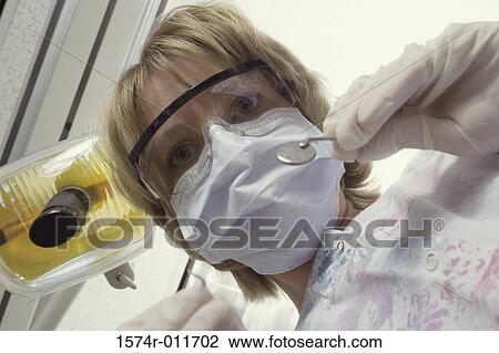 Portrait of a young female dentist holding instruments View Large Photo Image Stock Image - Portrait of a young female dentist holding instruments. Fotosearch