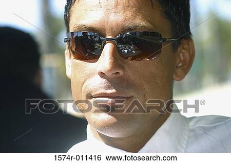 Stock Photograph - Portrait of a young man wearing sunglasses. Fotosearch
