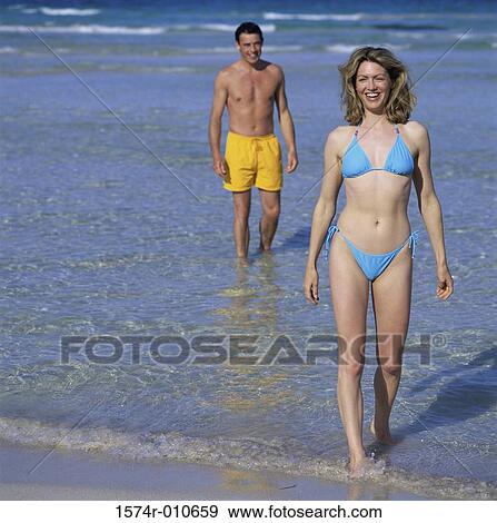 Portrait of a young woman and a young man at the beach View Large Photo Image Stock Photo - Portrait of a young woman and a young man at the beach. Fotosearch