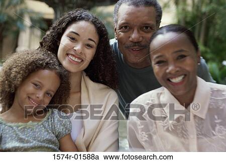 Stock Image - Portrait of grandparents with their daughter and their granddaughter. Fotosearch