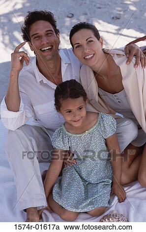 Stock Image - Portrait of parents sitting with their daughter. Fotosearch
