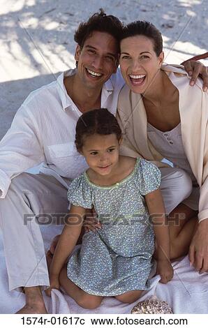 Portrait of parents sitting with their daughter View Large Photo Image Stock Image - Portrait of parents sitting with their daughter. Fotosearch