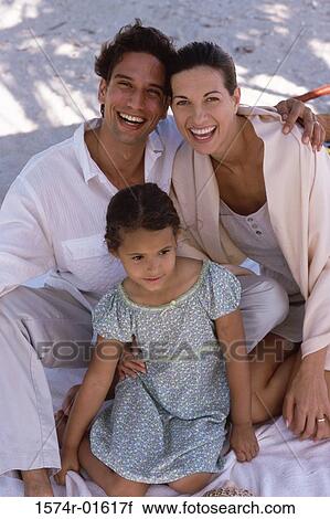 Stock Image - Portrait of parents sitting with their daughter. Fotosearch