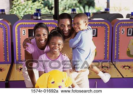Portrait of parents with their son and daughter at an amusement park View Large Photo Image Stock Image - Portrait of parents with their son and daughter at an amusement park. Fotosearch