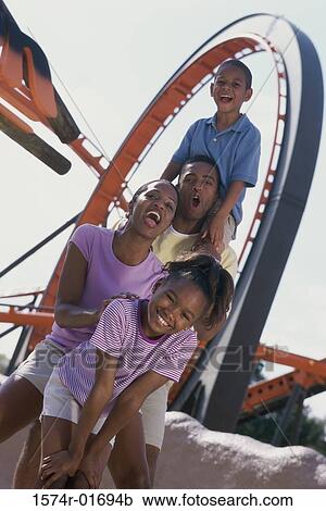Portrait of parents with their son and daughter at an amusement park View Large Photo Image Stock Image - Portrait of parents with their son and daughter at an amusement park. Fotosearch