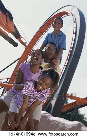 Portrait of parents with their son and daughter at an amusement park View Large Photo Image Stock Image - Portrait of parents with their son and daughter at an amusement park. Fotosearch