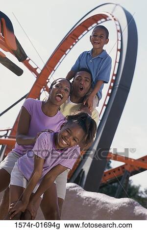 Portrait of parents with their son and daughter at an amusement park View Large Photo Image Stock Image - Portrait of parents with their son and daughter at an amusement park. Fotosearch