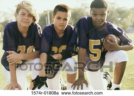 Portrait of three boys in football uniforms View Large Photo Image Stock Image - Portrait of three boys in football uniforms. Fotosearch