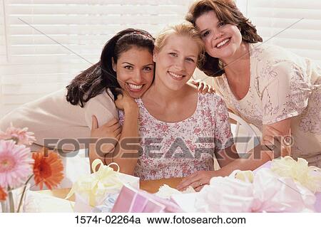 Stock Image - Portrait of three young women at a baby shower. Fotosearch