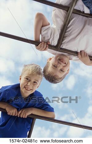 Portrait of two boys playing on monkey bars View Large Photo Image Stock Image - Portrait of two boys playing on monkey bars. Fotosearch
