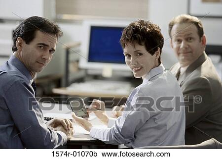 Portrait of two businessmen and a businesswoman smiling View Large Photo Image Stock Image - Portrait of two businessmen and a businesswoman smiling. Fotosearch