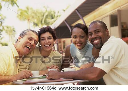 Stock Image - Portrait of two mature couples smiling. Fotosearch