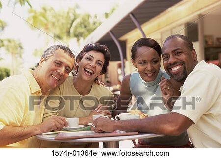 Stock Image - Portrait of two mature couples smiling. Fotosearch