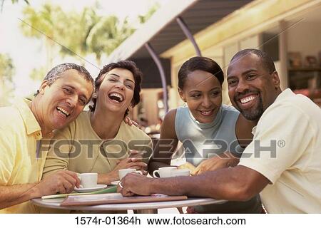 Stock Image - Portrait of two mature couples smiling. Fotosearch