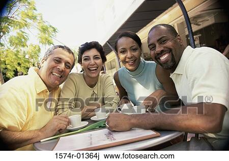 Stock Image - Portrait of two mature couples smiling. Fotosearch