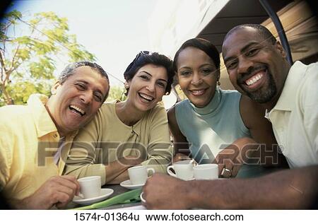 Stock Photograph - Portrait of two mature couples smiling. Fotosearch