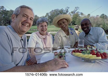 Portrait of two senior couples seated at a table View Large Photo Image Stock Image - Portrait of two senior couples seated at a table. Fotosearch
