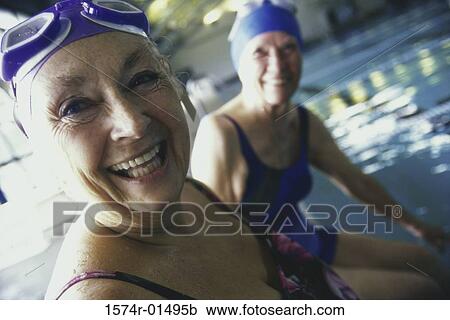 Stock Image - Portrait of two senior women at a swimming pool. Fotosearch