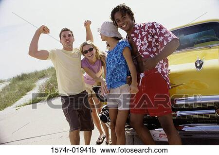 Portrait of two teenage couples standing beside a car View Large Photo Image Stock Image - Portrait of two teenage couples standing beside a car. Fotosearch