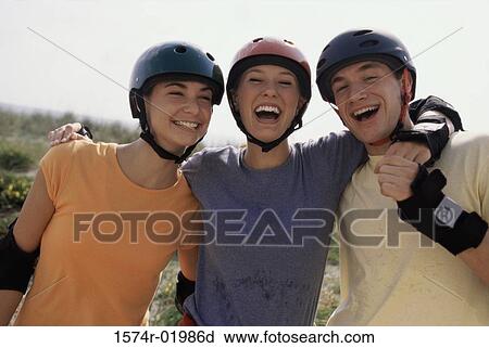 Portrait of two teenage girls and a teenage boy smiling View Large Photo Image Stock Image - Portrait of two teenage girls and a teenage boy smiling. Fotosearch