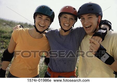 Stock Image - Portrait of two teenage girls and a teenage boy smiling. Fotosearch