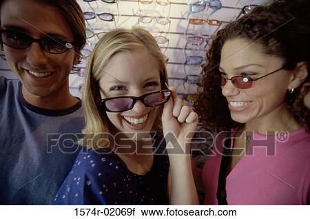 Portrait of two teenage girls and a teenage boy wearing sunglasses View Large Photo Image Stock Image - Portrait of two teenage girls and a teenage boy wearing sunglasses. Fotosearch
