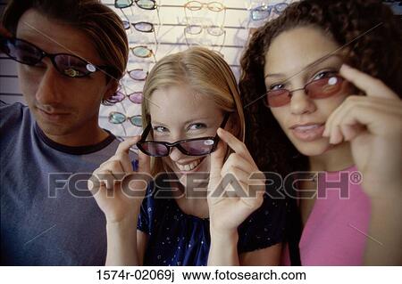 Portrait of two teenage girls and a teenage boy wearing sunglasses View Large Photo Image Stock Image - Portrait of two teenage girls and a teenage boy wearing sunglasses. Fotosearch