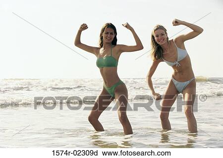 Stock Image - Portrait of two teenage girls posing on the beach. Fotosearch