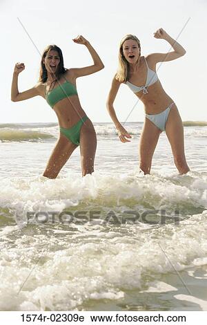 Stock Image - Portrait of two teenage girls posing on the beach. Fotosearch
