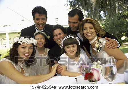 Stock Image - Portrait of wedding guests with a newlywed couple. Fotosearch