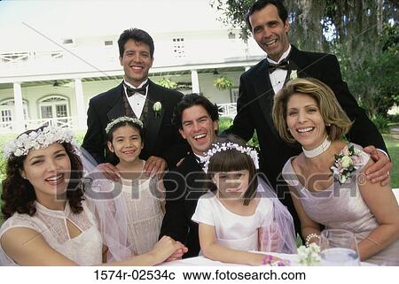 Stock Image - Portrait of wedding guests with a newlywed couple. Fotosearch