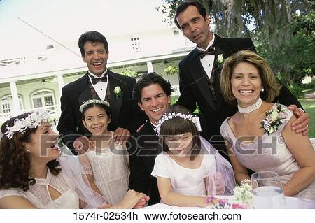 Stock Image - Portrait of wedding guests with a newlywed couple. Fotosearch