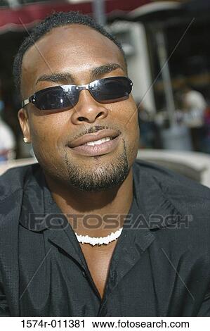 Portrait of young man wearing sunglasses View Large Photo Image Stock Image - Portrait of young man wearing sunglasses. Fotosearch