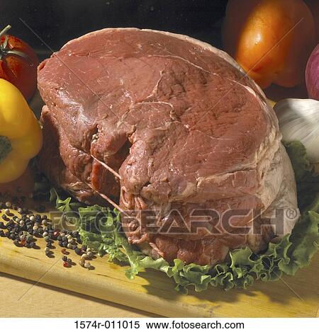 Stock Photography - Raw meat on a cutting board. Fotosearch
