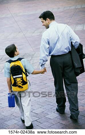 Rear view of a father and his son holding hands View Large Photo Image Stock Image - Rear view of a father and his son holding hands. Fotosearch