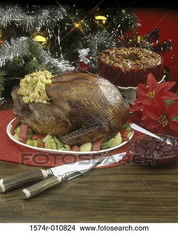 Roast turkey with stuffing and a fruitcake View Large Photo Image Picture - Roast turkey with stuffing and a fruitcake. Fotosearch