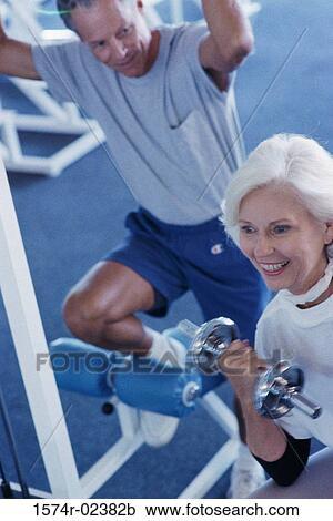 Senior couple exercising in a health club View Large Photo Image Stock Image - Senior couple exercising in a health club. Fotosearch
