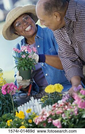 Stock Image - Senior couple gardening. Fotosearch