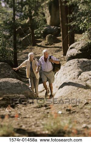 Senior couple hiking in the woods View Large Photo Image Stock Image - Senior couple hiking in the woods. Fotosearch