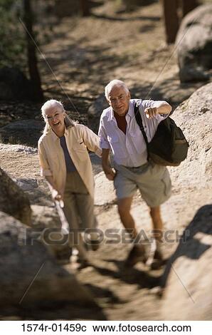 Senior couple hiking over a rugged landscape View Large Photo Image Stock Image - Senior couple hiking over a rugged landscape. Fotosearch