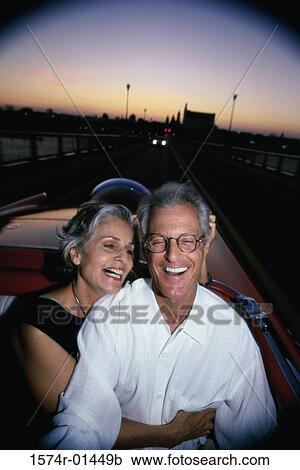 Stock Image - Senior couple sitting in a convertible car. Fotosearch