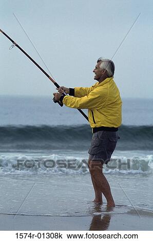 Stock Image - Senior man fishing at the beach. Fotosearch