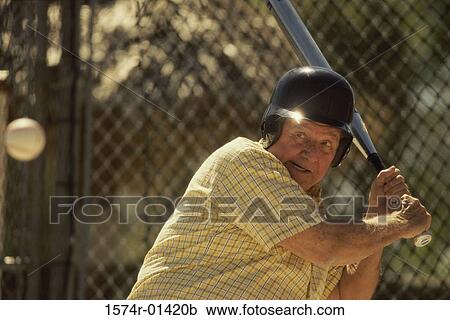 Senior man swinging a baseball bat View Large Photo Image Stock Image - Senior man swinging a baseball bat. Fotosearch