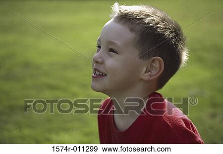 Side profile of a boy smiling View Large Photo Image Stock Photo - Side profile of a boy smiling. Fotosearch