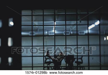 Stock Image - Side profile of a businessman resting in a conference room. Fotosearch