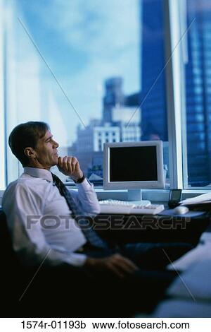 Side profile of a businessman sitting with his hand on his chin View Large Photo Image Stock Image - Side profile of a businessman sitting with his hand on his chin. Fotosearch